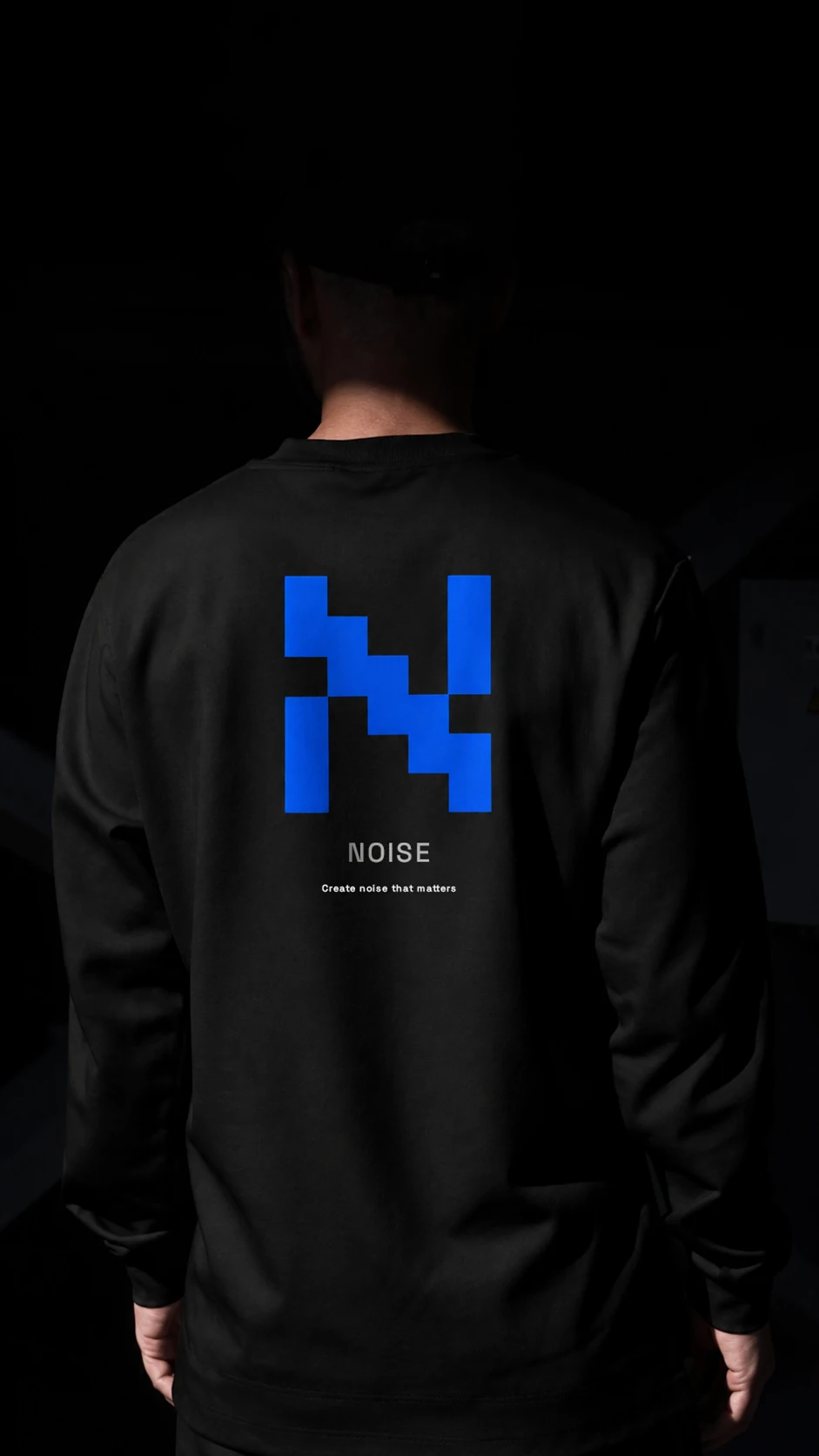Black apparel with a blue NOISE pixel symbol on the back
